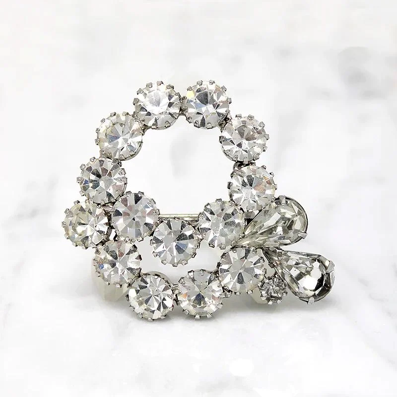 Vivacious White Rhinestone Swirl Brooch