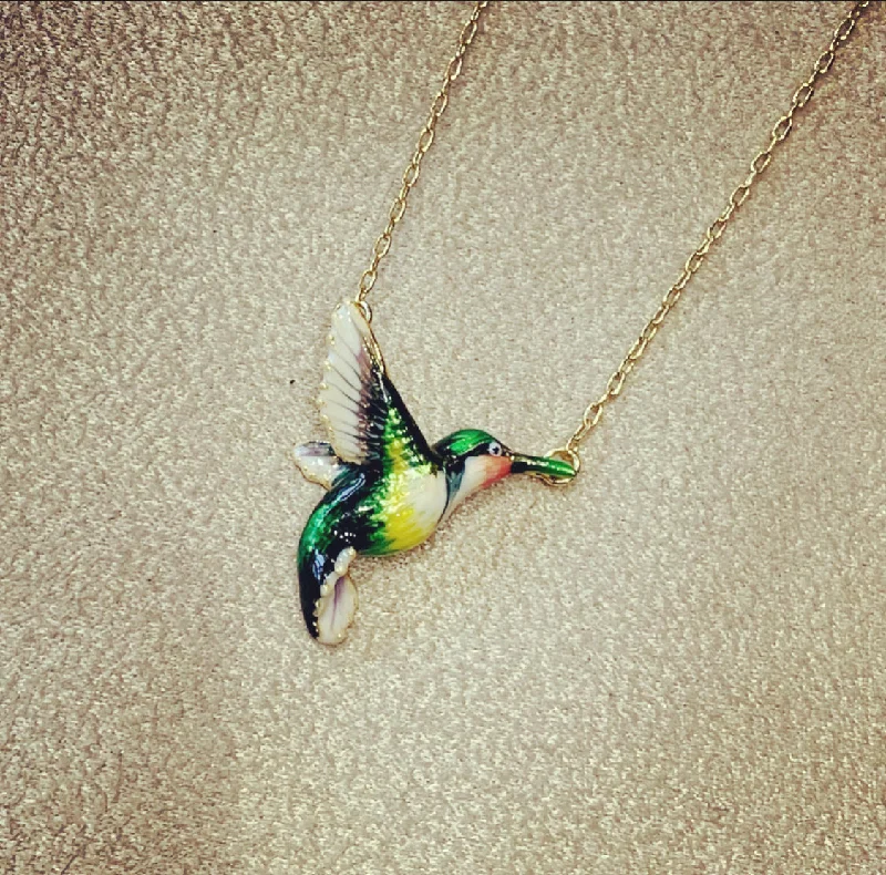 Hummingbird pendant necklace by Bill Skinner with blue green enamel